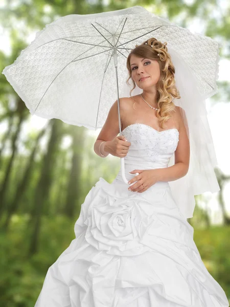 Beautiful bride outdoors in a forest — Stock Photo, Image