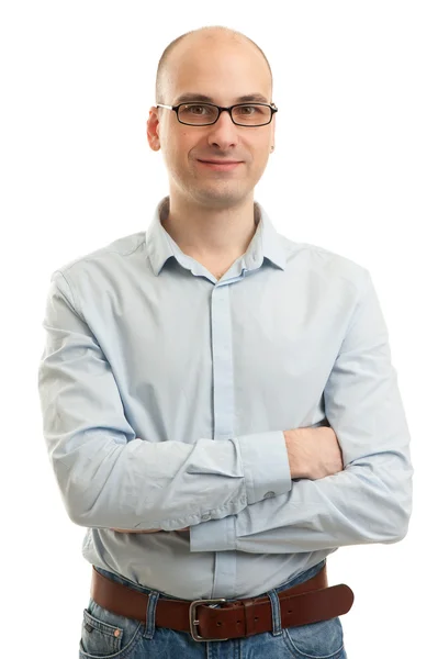 Smiling man standing with his arms folded against white backgrou Stock Photo