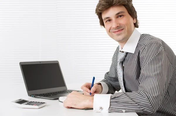 Male executive working on laptop computer at office Stock Picture