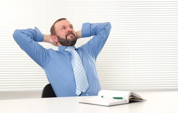 Älterer Mann sitzt in seinem Büro — Stockfoto