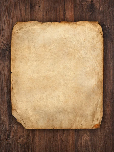 Old paper on brown wood texture — Stock Photo, Image