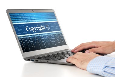 hands typing on laptop. Copyright message concept clipart