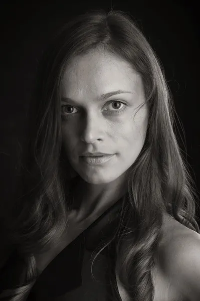 Portrait of a beautiful woman on a black background — Stock Photo, Image