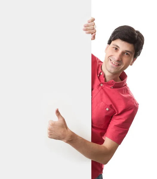 Feliz sonriente hombre sostiene un tablero en blanco y muestra los pulgares hacia arriba —  Fotos de Stock