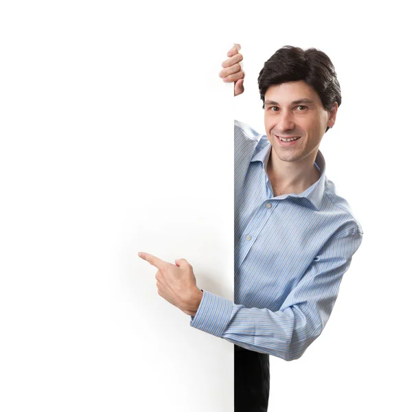 Feliz sorridente jovem homem de negócios mostrando placa em branco — Fotografia de Stock
