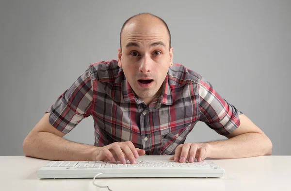 Homme choqué en utilisant le clavier — Photo