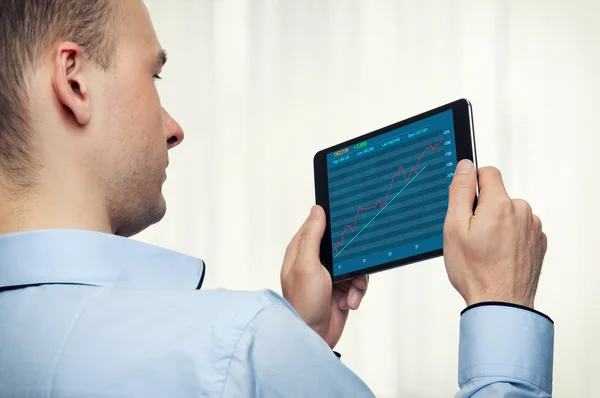 Mann hält digitales Tablet mit Börsendiagramm — Stockfoto