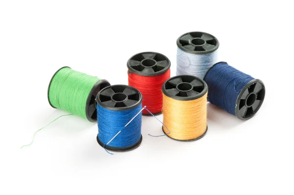 Bobbin threads with needle — Stock Photo, Image