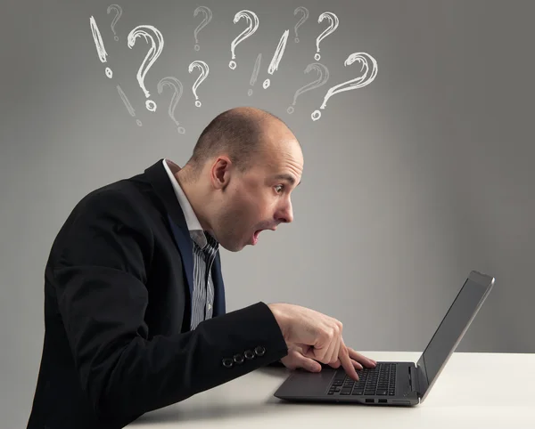 Surprised businessman looking at his laptop — Stock Photo, Image