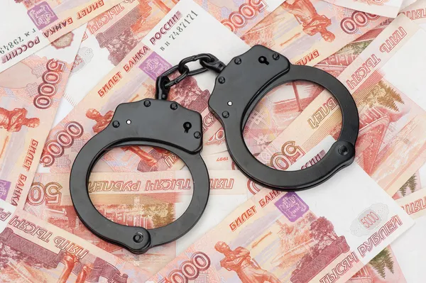 Handcuffs on Russian money — Stock Photo, Image