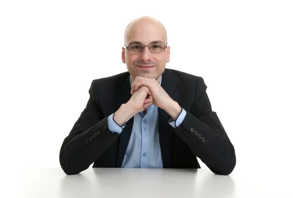 Cheerful businessman sitting at a table — Stock Photo, Image