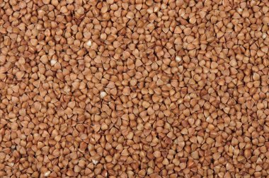 dry buckwheat background texture top view. Natural healty food, vegan diet.