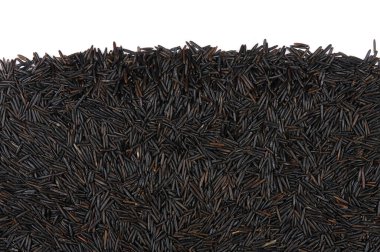 uncooked wild black rice isolated on white background. Top view