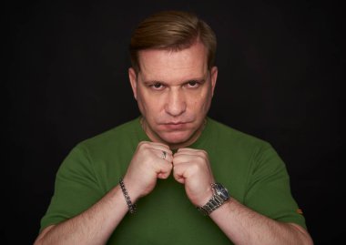 Studio portrait of a middle aged handsome male in green t-shirt