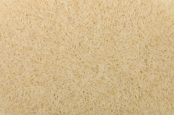 煮半熟的长粒香大米的背景 — 图库照片