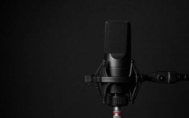 Siyah arka planda profesyonel mikrofon. Podcast veya kayıt stüdyosu