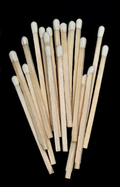 A bunch of wooden matches isolated on a black background clipart
