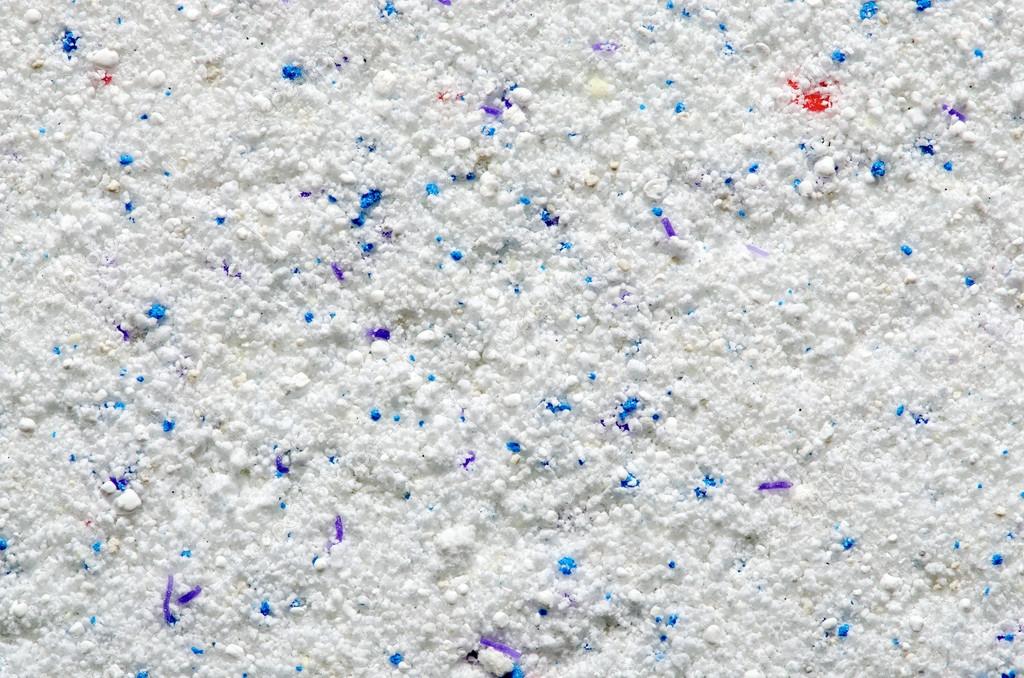 Washing powder texture with blue and red disseminations