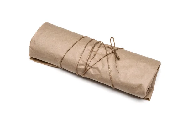 Parcel package wrapped with brown kraft paper tied rope isolated Royalty Free Stock Images