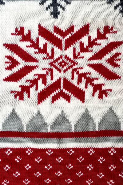 Sfondo lavorato a maglia con ornamento natalizio — Foto Stock