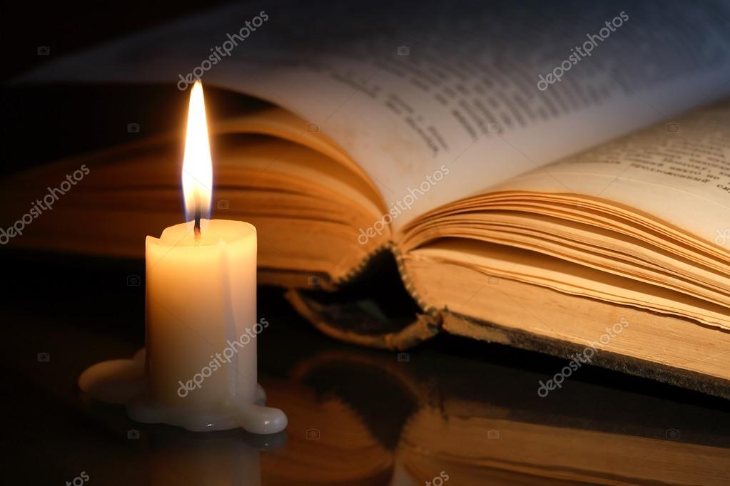 old open book with candle