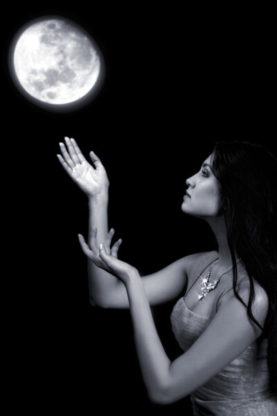 Attractive fairy girl pulls hands to the moon