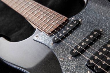 soundboard of an electric guitar close-up. stratocaster, humbucker and 2 singles