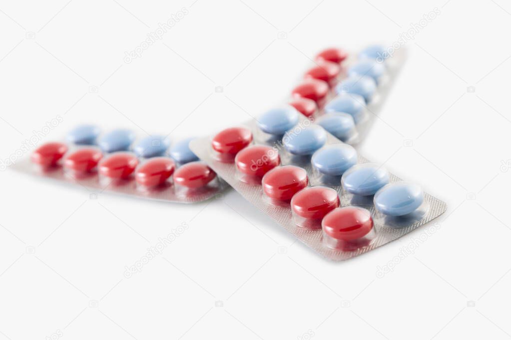 packaging of pills blue and red pills on white background