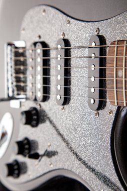 soundboard of an electric guitar close-up. shape of stratocaster, humbucker and 2 singles