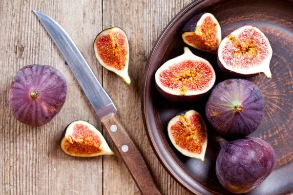 Plate with fresh figs and old knife Royalty Free Stock Images