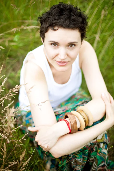 Young cute girl resting on fresh spring grass — Stock Photo, Image