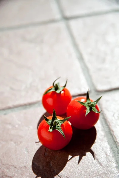 Três tomates cereja — Fotografia de Stock