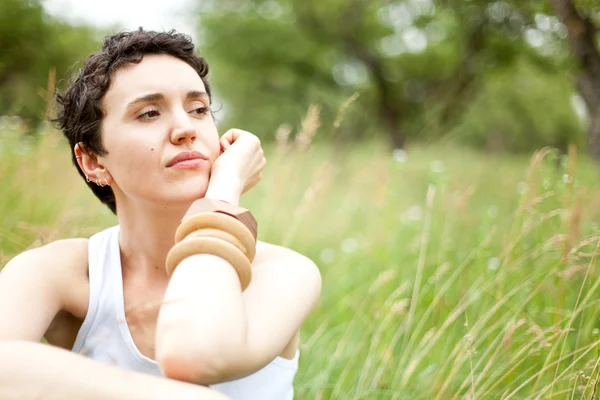 Cute girl on green field — Stock Photo, Image