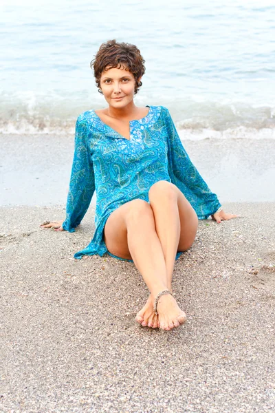 Woman in blue dress on the beach — Stock Photo, Image