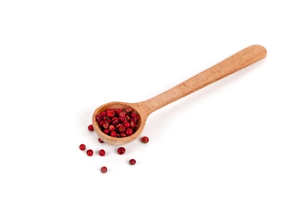 Pink pepper in a wooden spoon — Stock Photo, Image