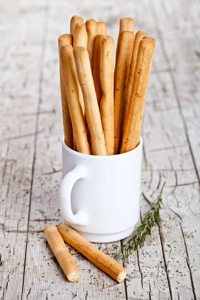 Cup with bread sticks grissini and rosemary — Stock Photo, Image