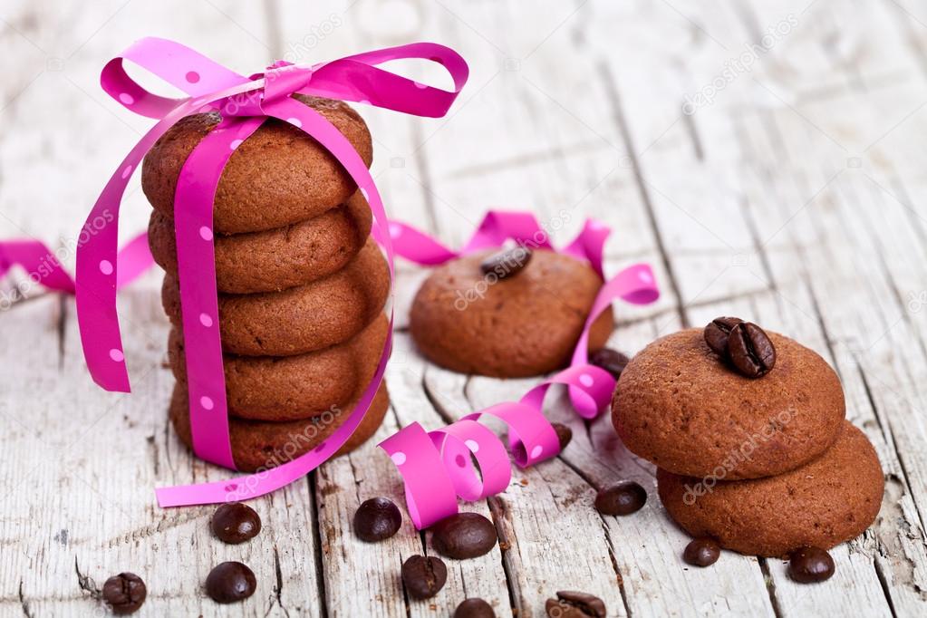 stack of chocolate cookies tied with pink ribbon and coffee bean