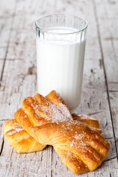 Glas Milch und zwei frisch gebackene Brötchen — Stockfoto