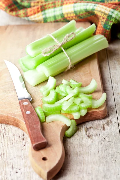 Bundle of fresh green celery stems and knife — Stock Photo, Image