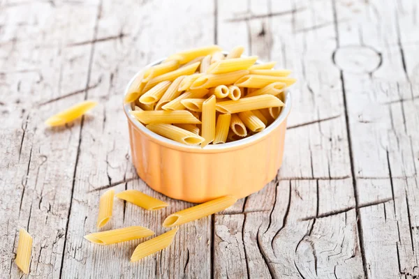 Uncooked pasta in a bowl — Stock Photo, Image