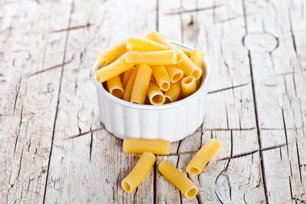 Uncooked pasta in a bowl — Stock Photo, Image