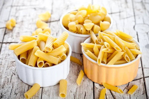 Uncooked pasta in three bowls — Stock Photo, Image