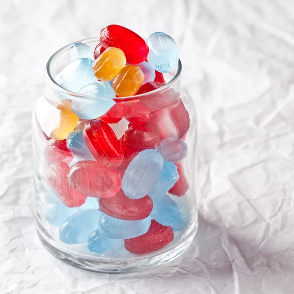 Colorful candies in glass jar — Stock Photo, Image