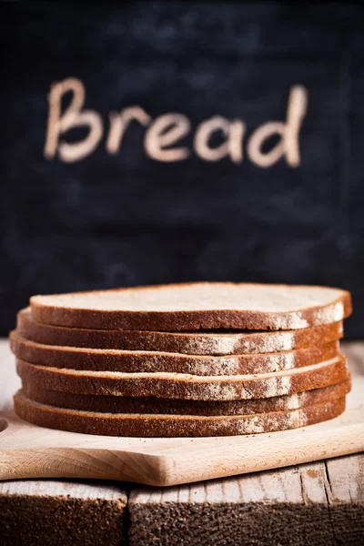 Slices of rye bread and blackboard — Stock Photo, Image