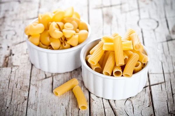 Uncooked pasta in two bowls — Stock Photo, Image