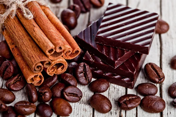 Doces de chocolate, canela e grãos de café — Fotografia de Stock