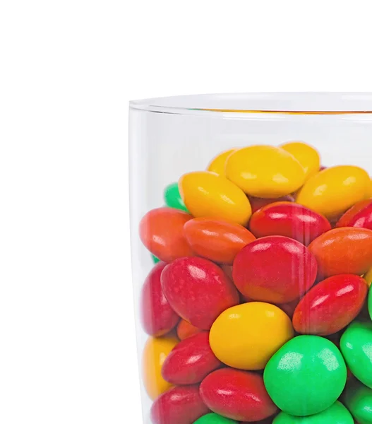 Color dragees in a glass vessel — Stock Photo, Image
