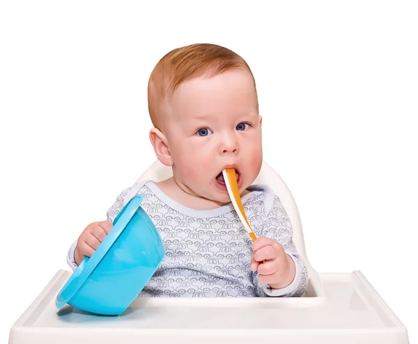 The child on a chair for feeding on the white — Stock Photo, Image