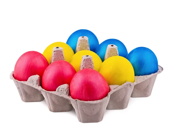 Ovos multicoloridos brilhantes nas células em um fundo branco — Fotografia de Stock