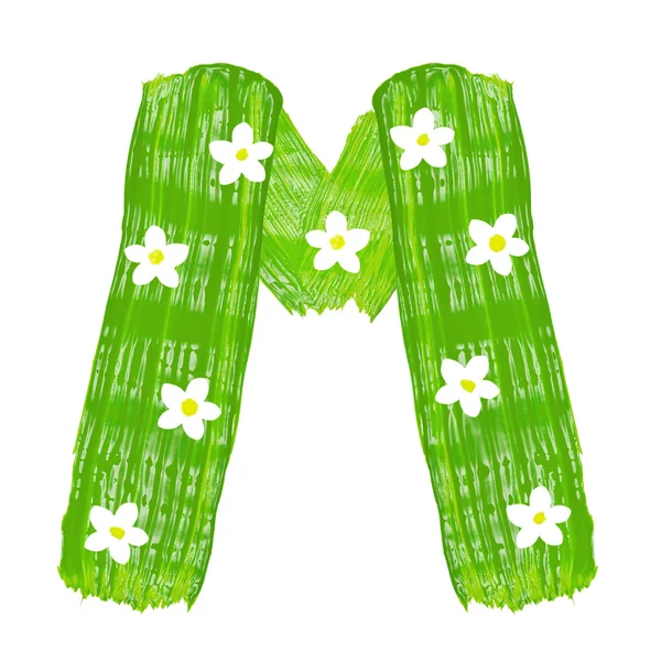 The green letters M drawn by paints with white blossom — Stock Photo, Image